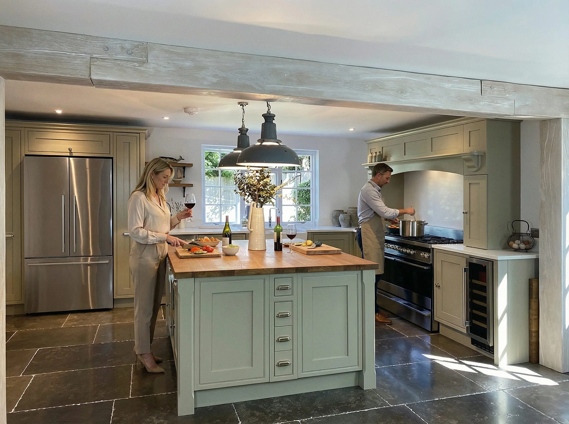 Luxury handmade kitchen with nautical style handles and limewashed oak beam.